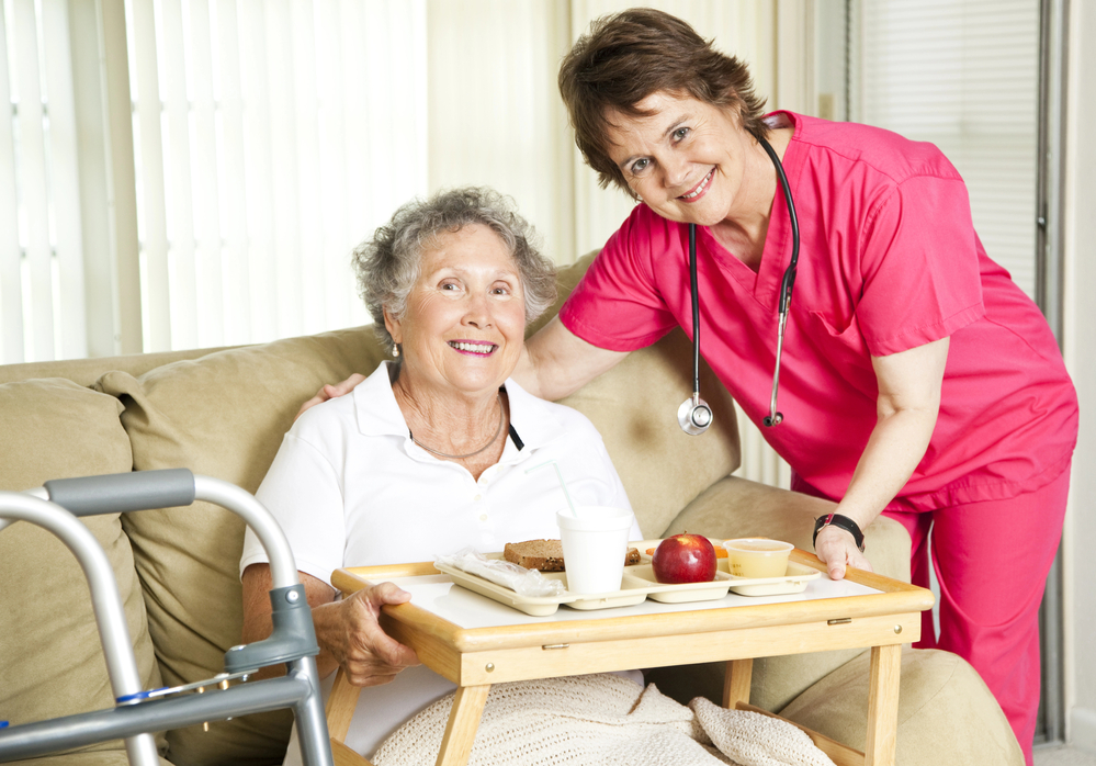 Nurse smiles with elderly patient at Headwaters Hospice and Palliative Care