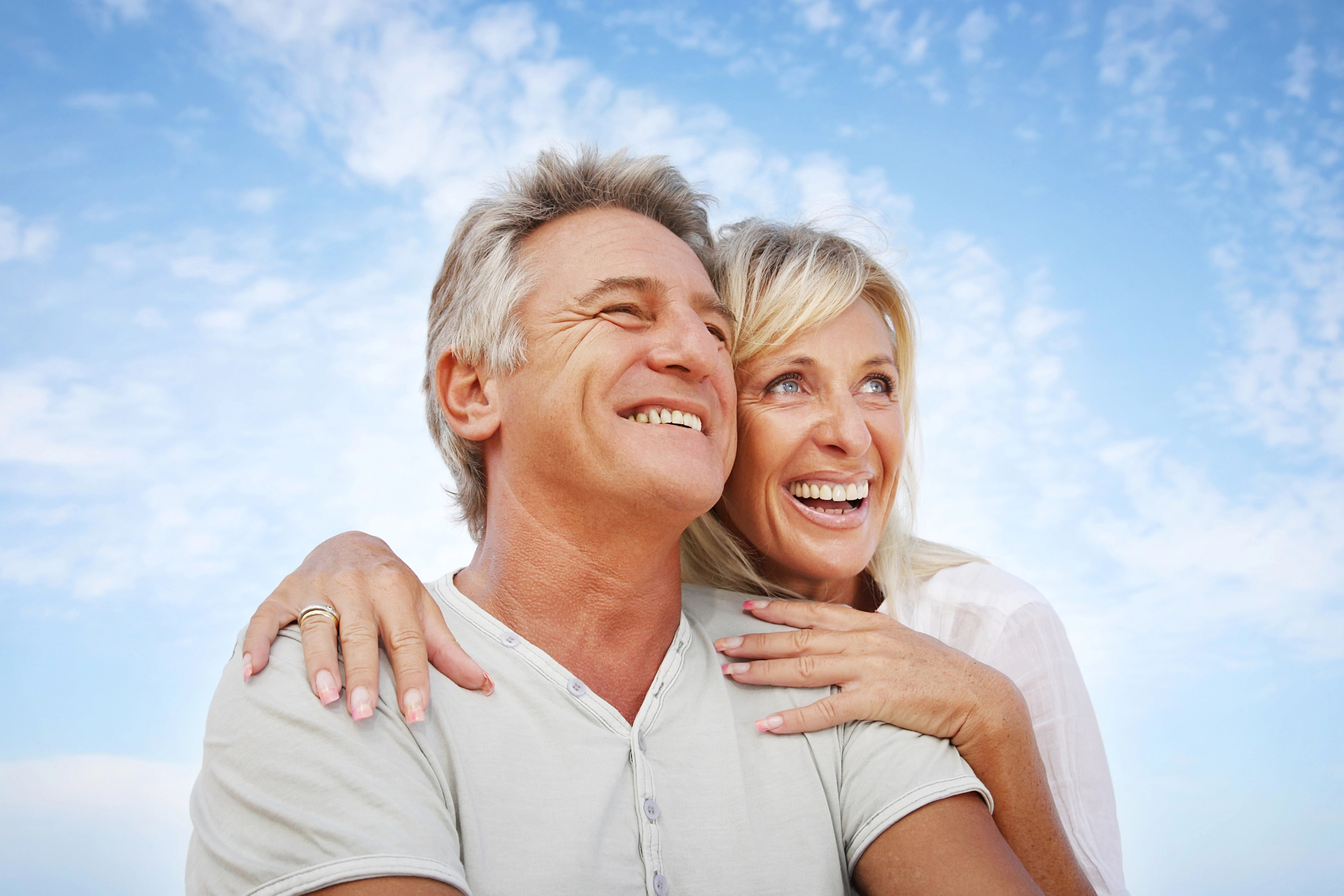 Elderly couple embracing and smiling after securing Helena, MT Elderly Caregiver Services